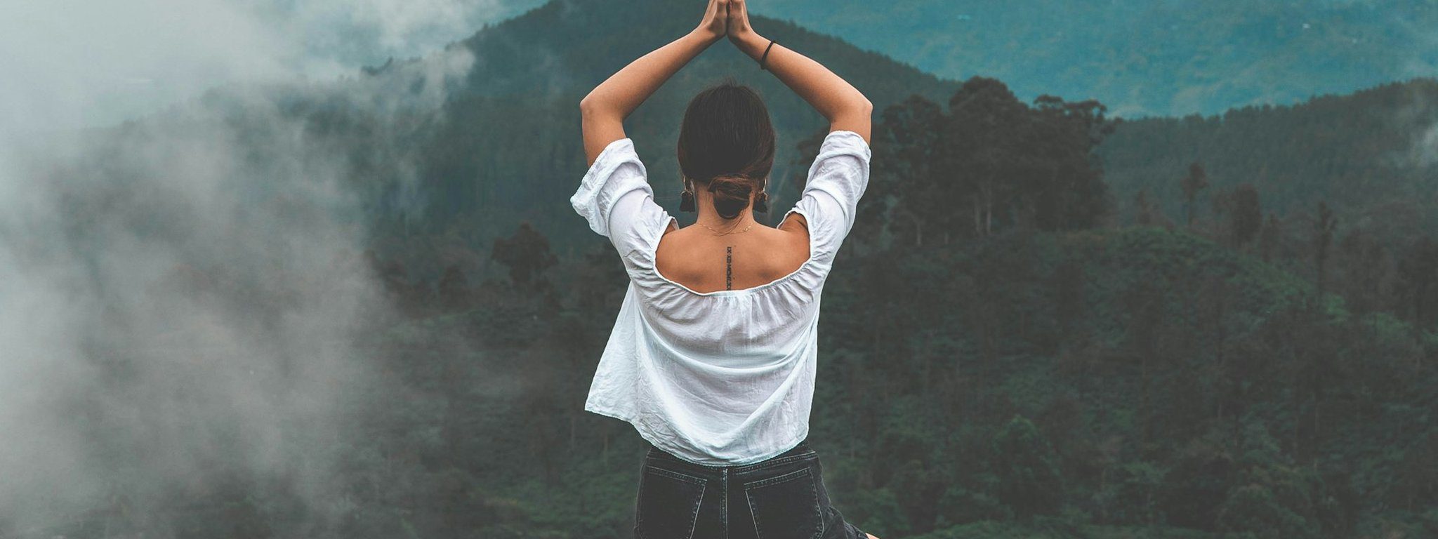 Woman practising yoga and meditation at a wellness retreat