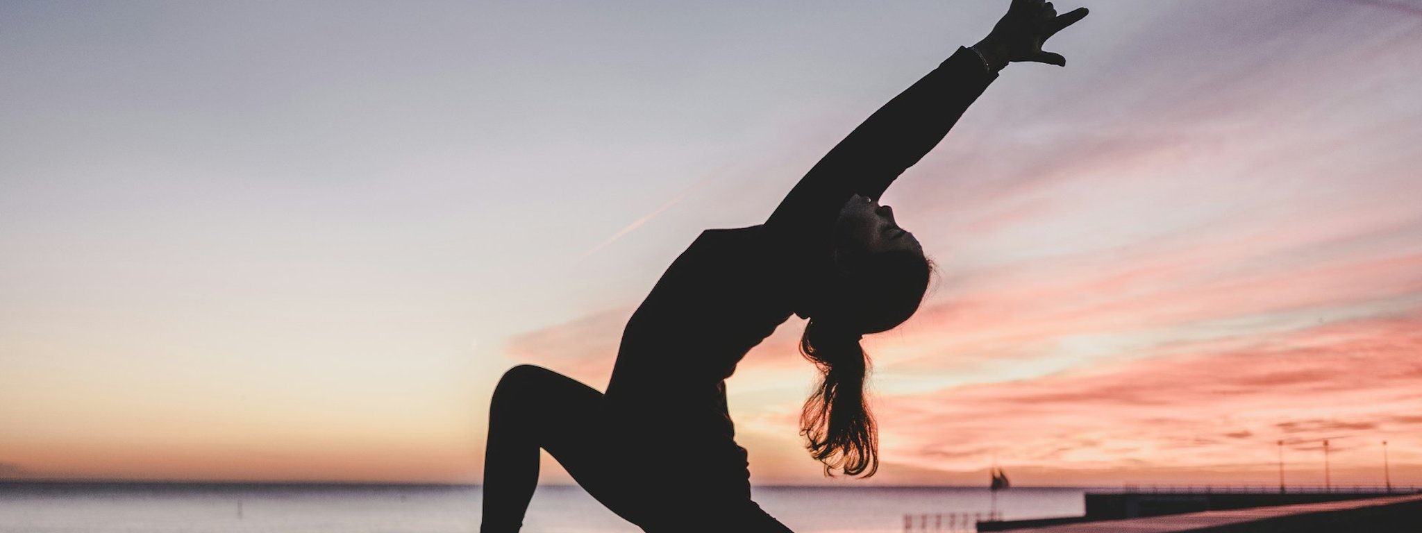 Women practising yoga together at a peaceful outdoor retreat setting